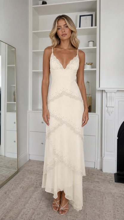 Front view of model wearing champagne embellished tiered maxi dress