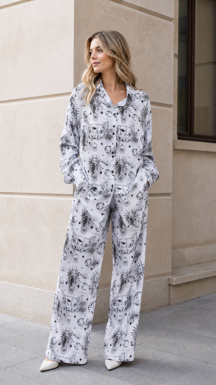 Front full view of woman wearing white celestial print long sleeve pajama set