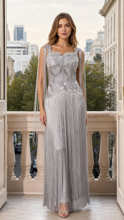 Front full view of woman wearing silver beaded fringe maxi evening gown on balcony