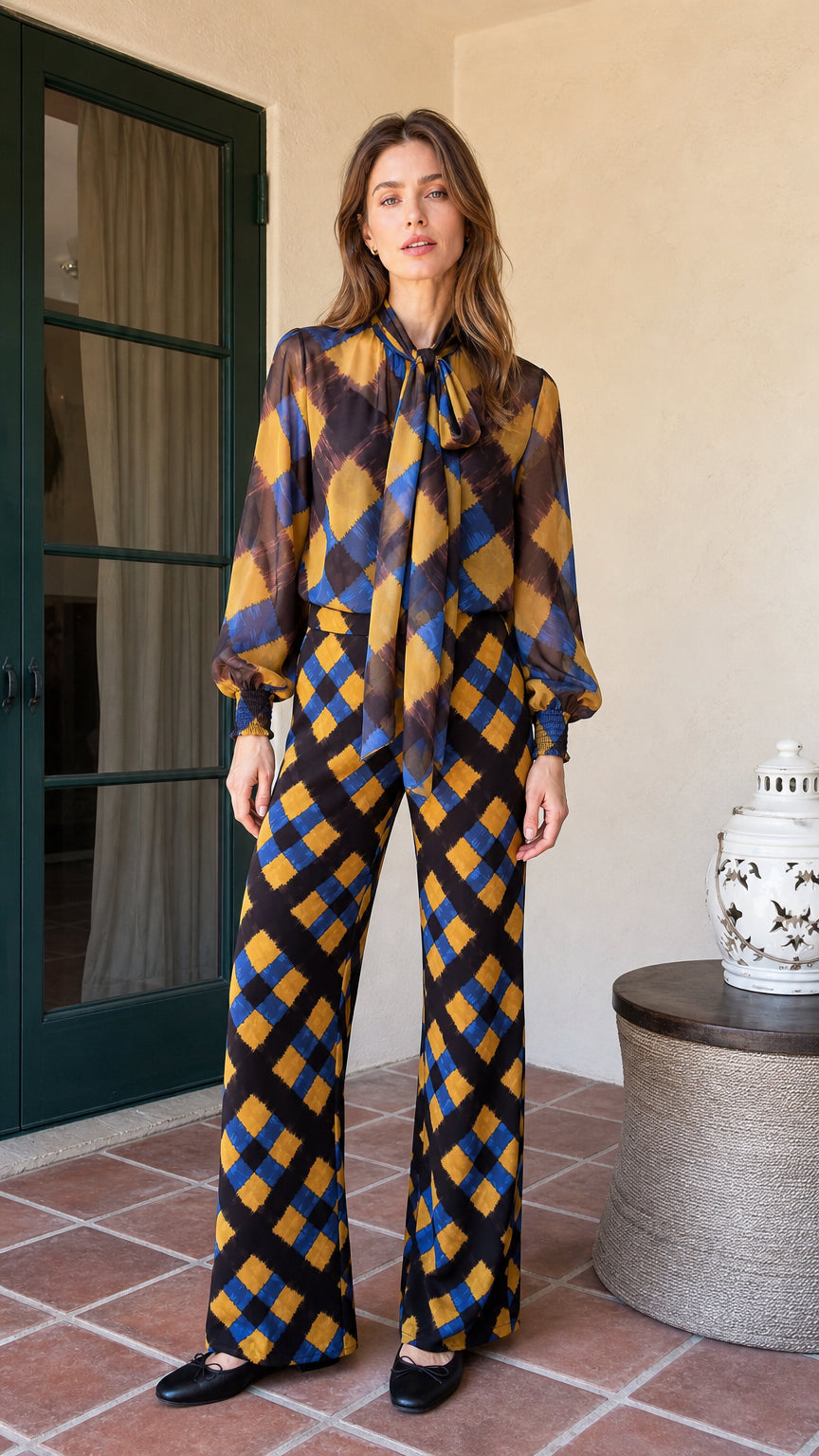 Front view of model wearing mustard and blue plaid tie-neck blouse and wide-leg pants set