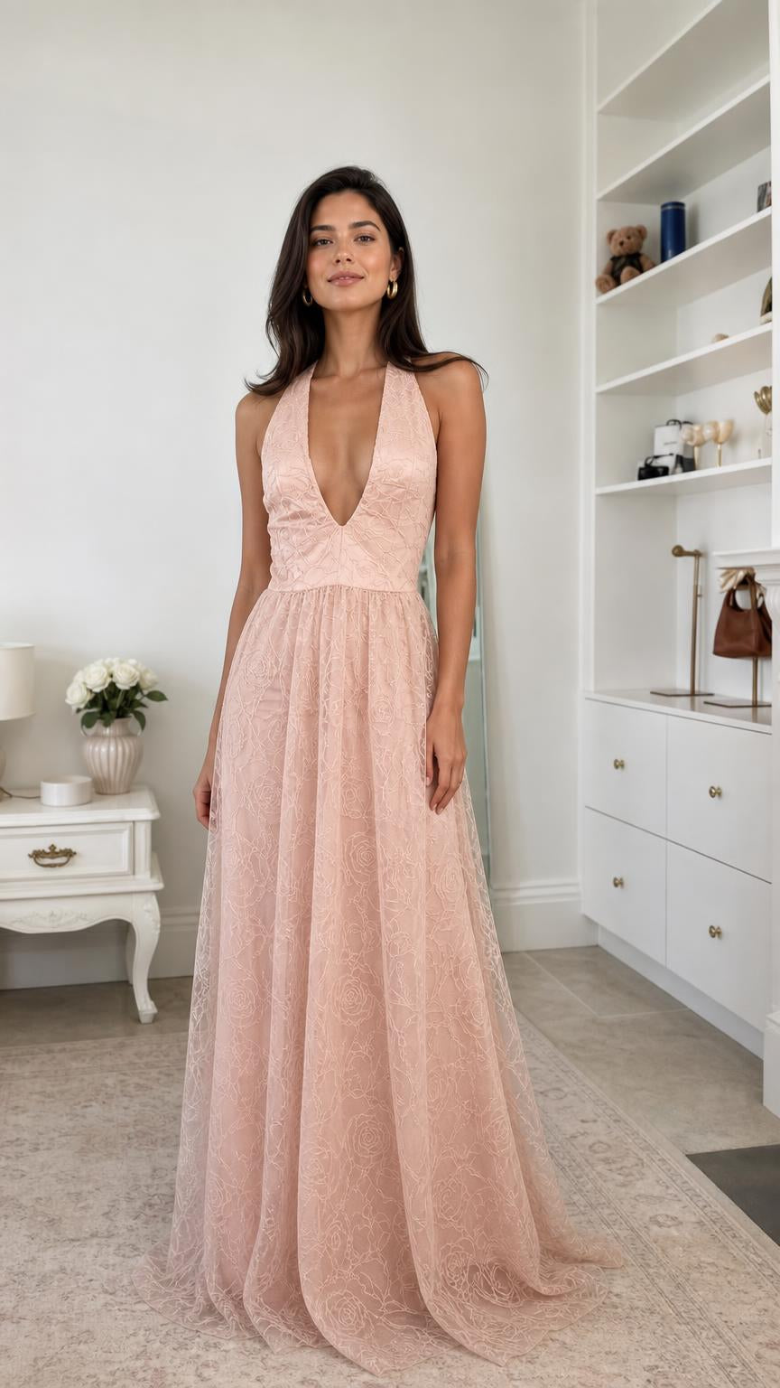 Front view of model wearing blush pink lace halter maxi evening dress