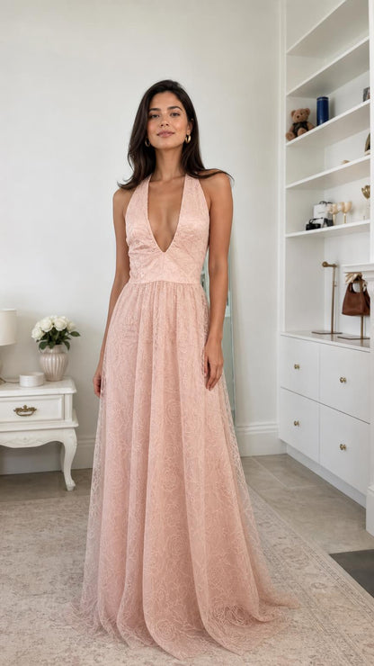 Front view of model wearing blush pink lace halter maxi evening dress