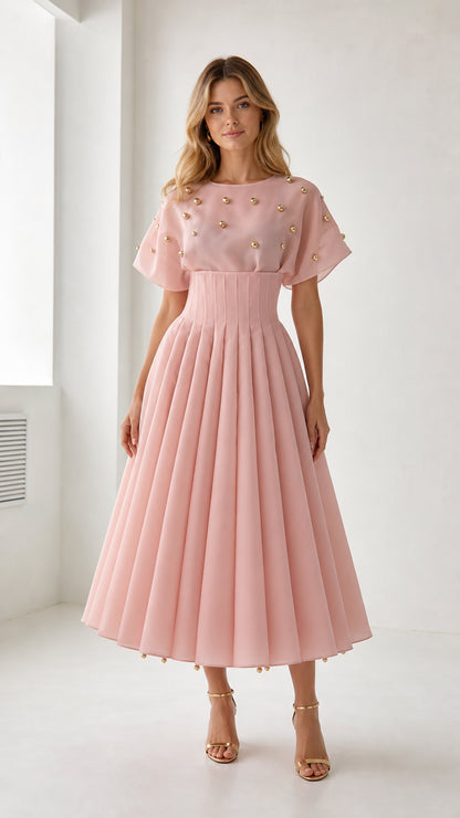Front view of model wearing pink pearl embellished pleated midi dress