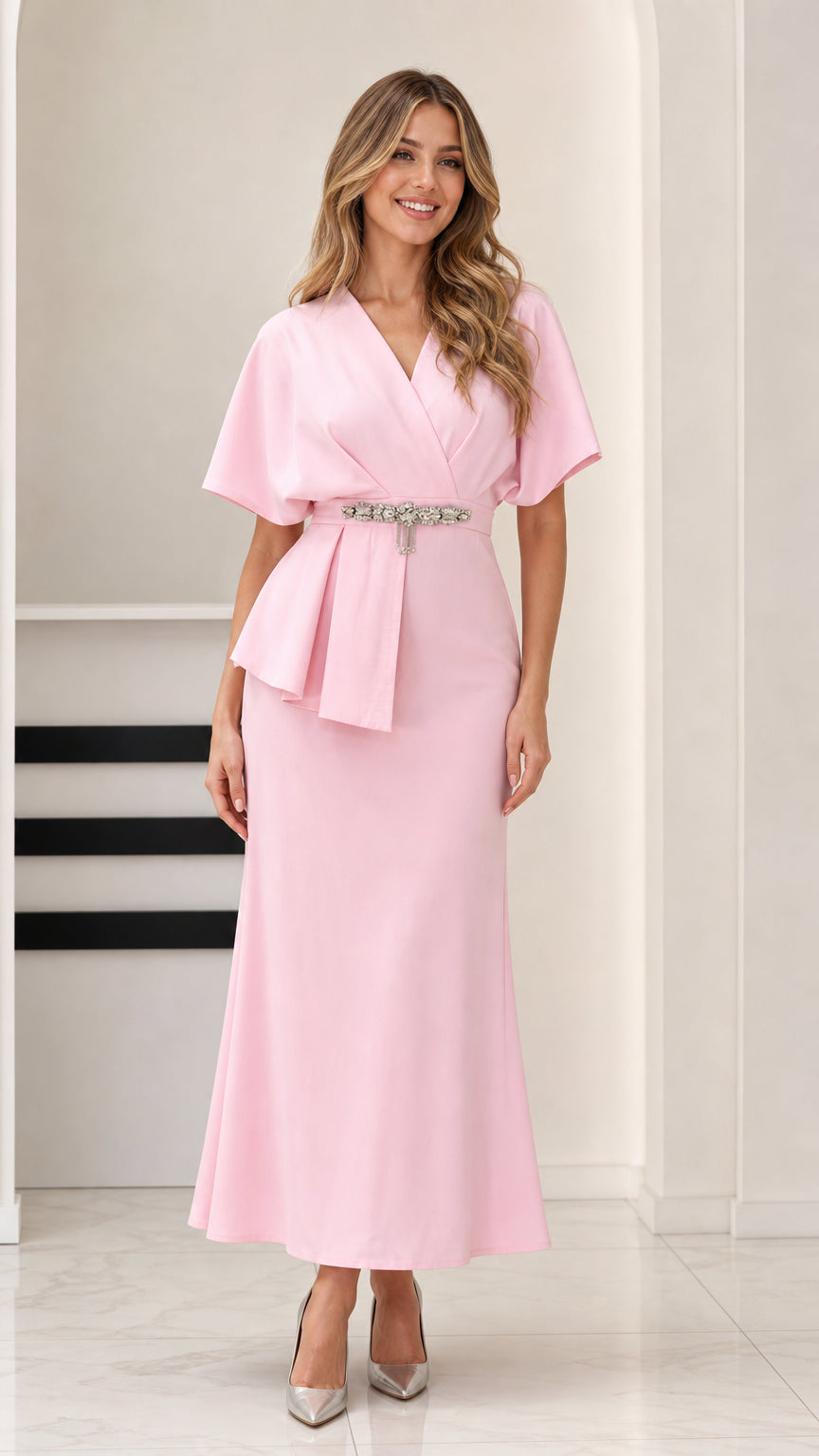 Full front view of model wearing Light Pink flutter sleeve peplum maxi dress with crystal waist detail