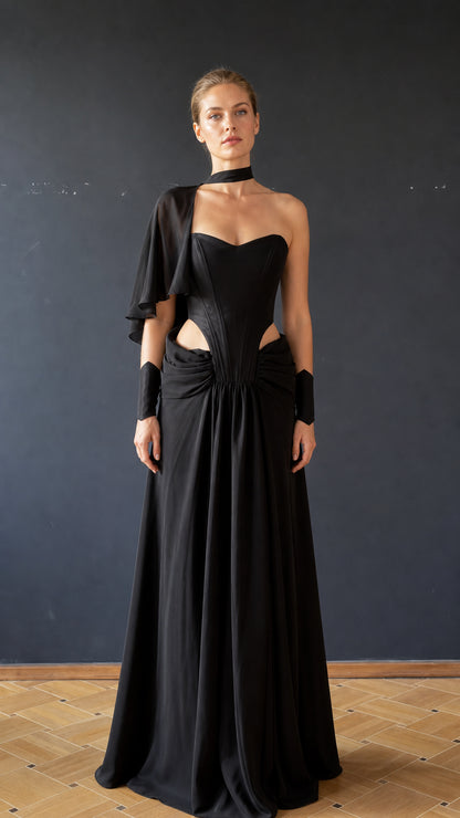 Front view of black cutout draped maxi evening dress with choker and cuffs