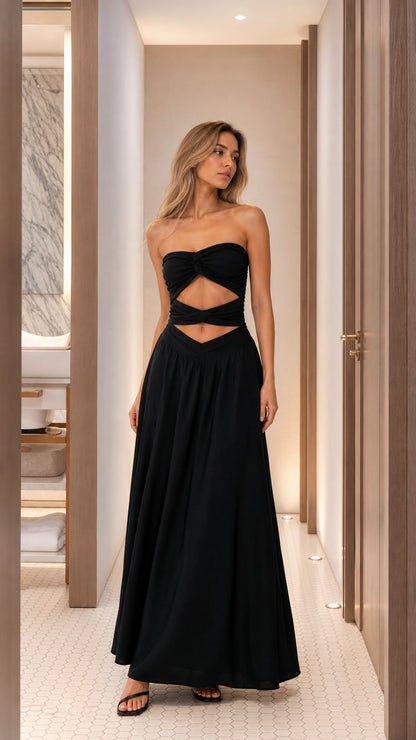 Front view of woman wearing black cutout strapless maxi dress
