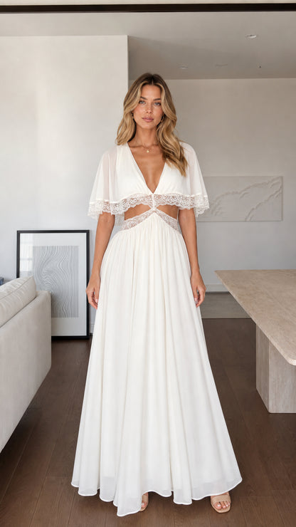 Front view of woman wearing white maxi dress with lace cut-outs