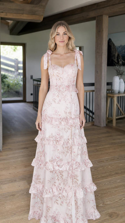 Front view of model wearing pink floral tiered maxi dress