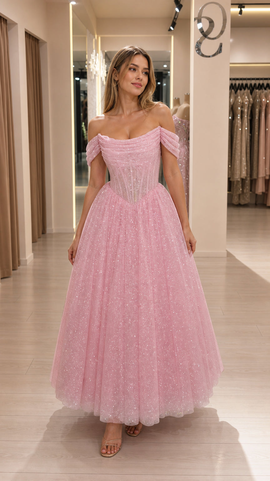 Front view of model wearing pink off-shoulder glitter tulle corset midi dress