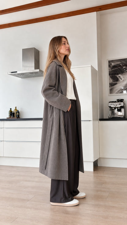 Model wearing grey wool-look trench coat side view