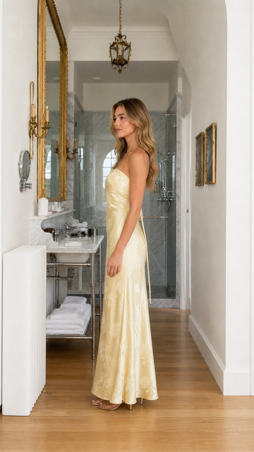 Side profile view of yellow strapless maxi dress