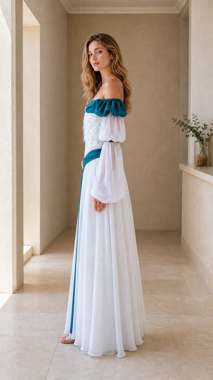 Side view of model wearing white and teal fantasy gown showing draping chiffon skirt