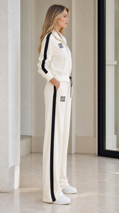 Side profile of model in Cream tracksuit showing contrast side stripe detailing