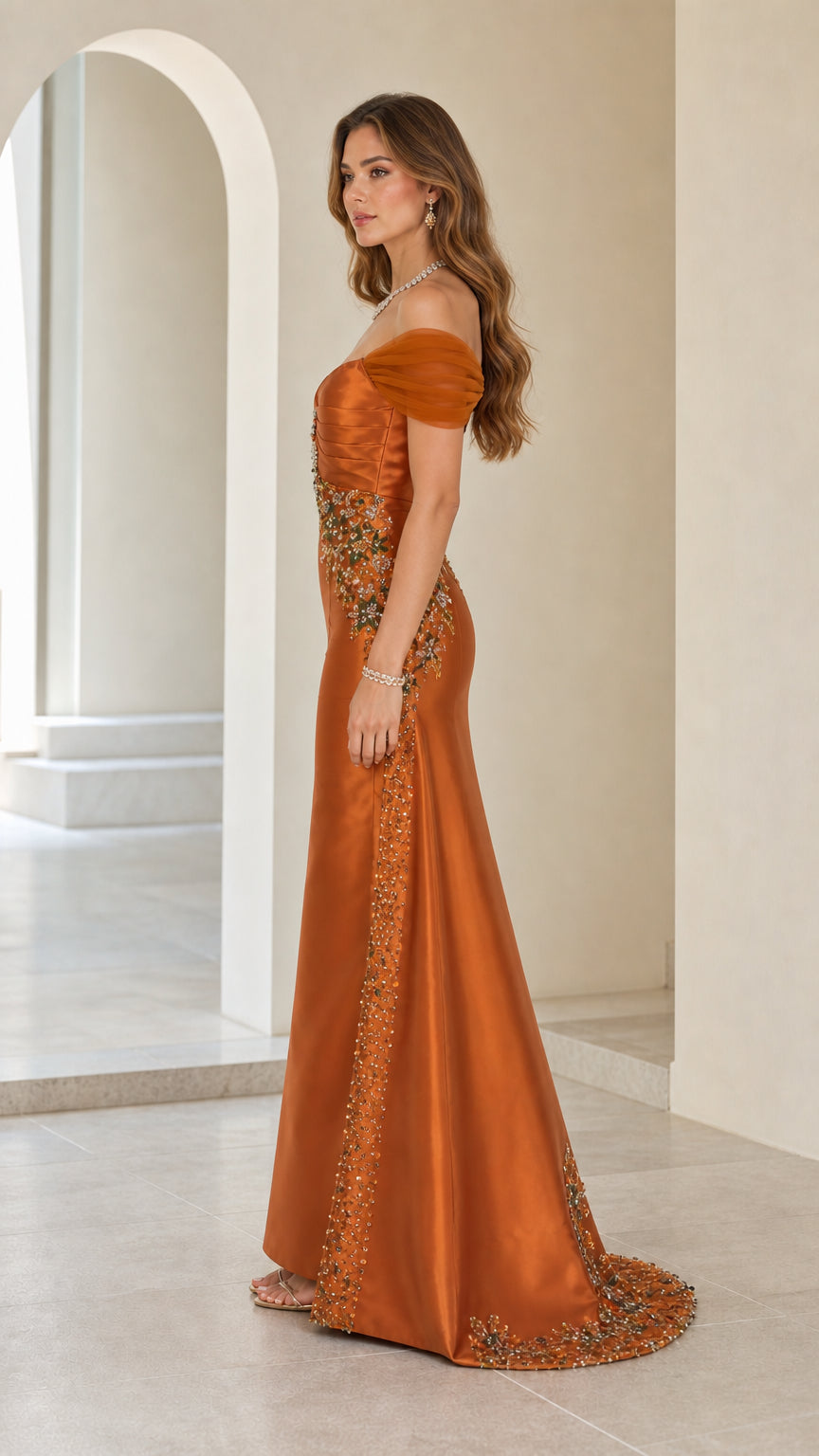 Side profile view of rust orange satin evening gown with sweep train