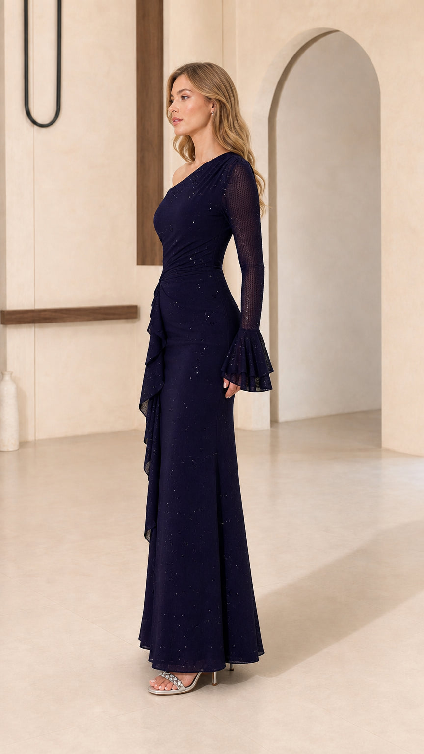 Model wearing navy one-shoulder evening gown, side view