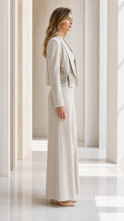 Side profile of woman in champagne tailored evening pant suit with cropped jacket