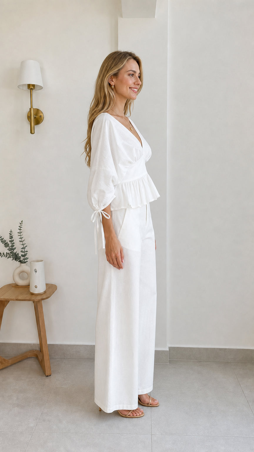 Side profile view of model in white two-piece set