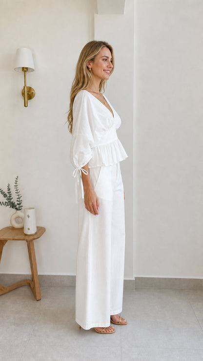 Side profile view of model in white two-piece set