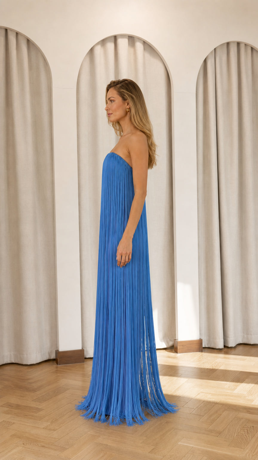 Side profile view of blue fringe maxi dress