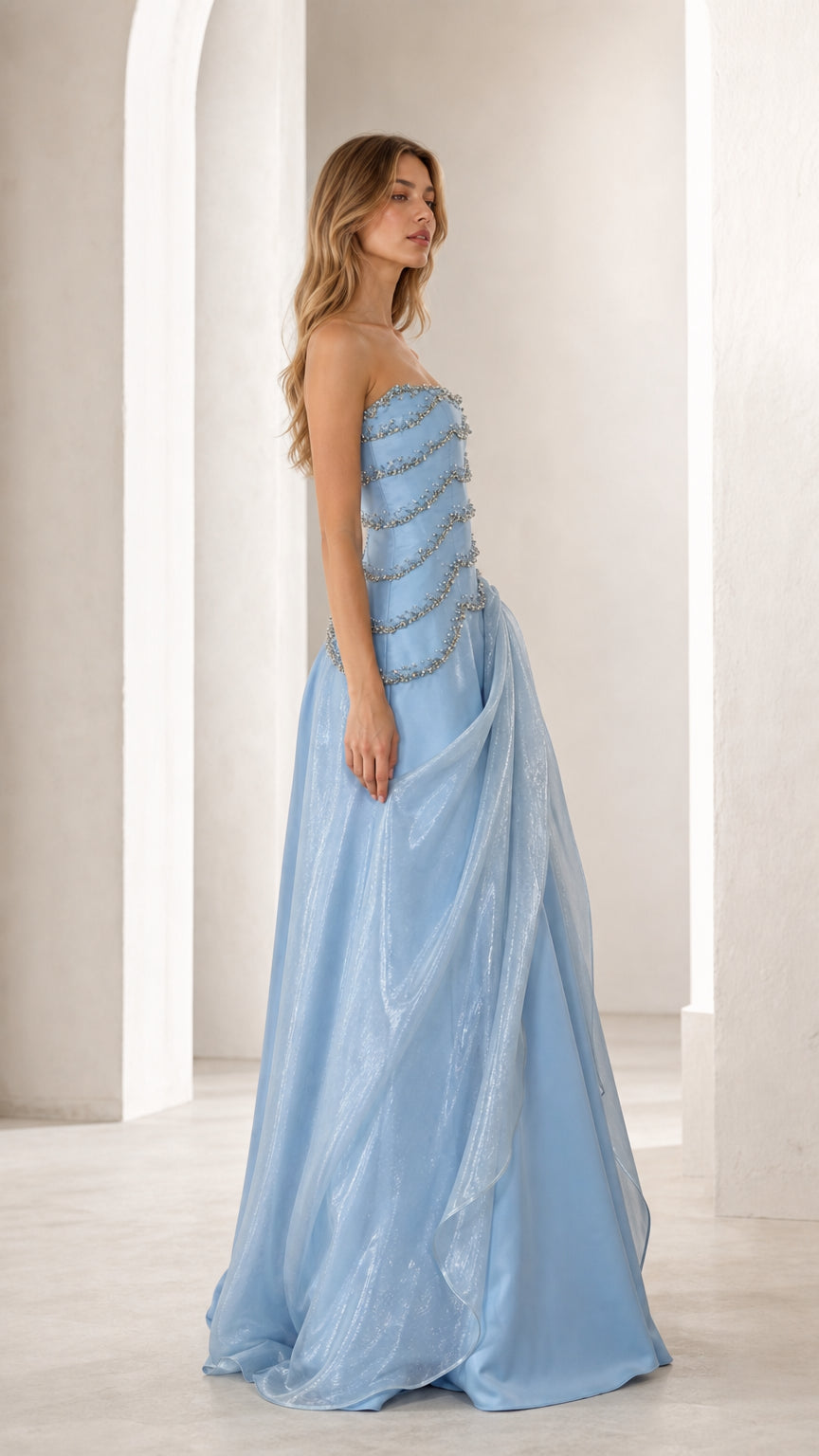 Side profile of sky blue formal gown with draped shimmer skirt