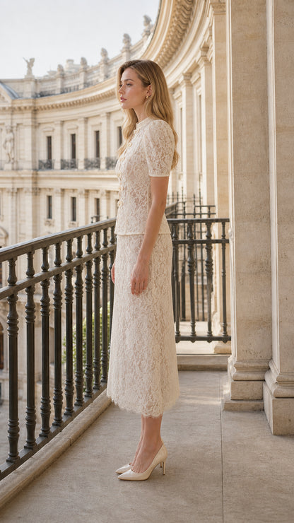 Side profile view of model in cream lace top and matching midi skirt