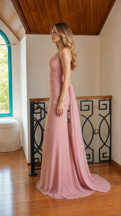 Side profile of woman in dusty rose evening gown showing cascading train