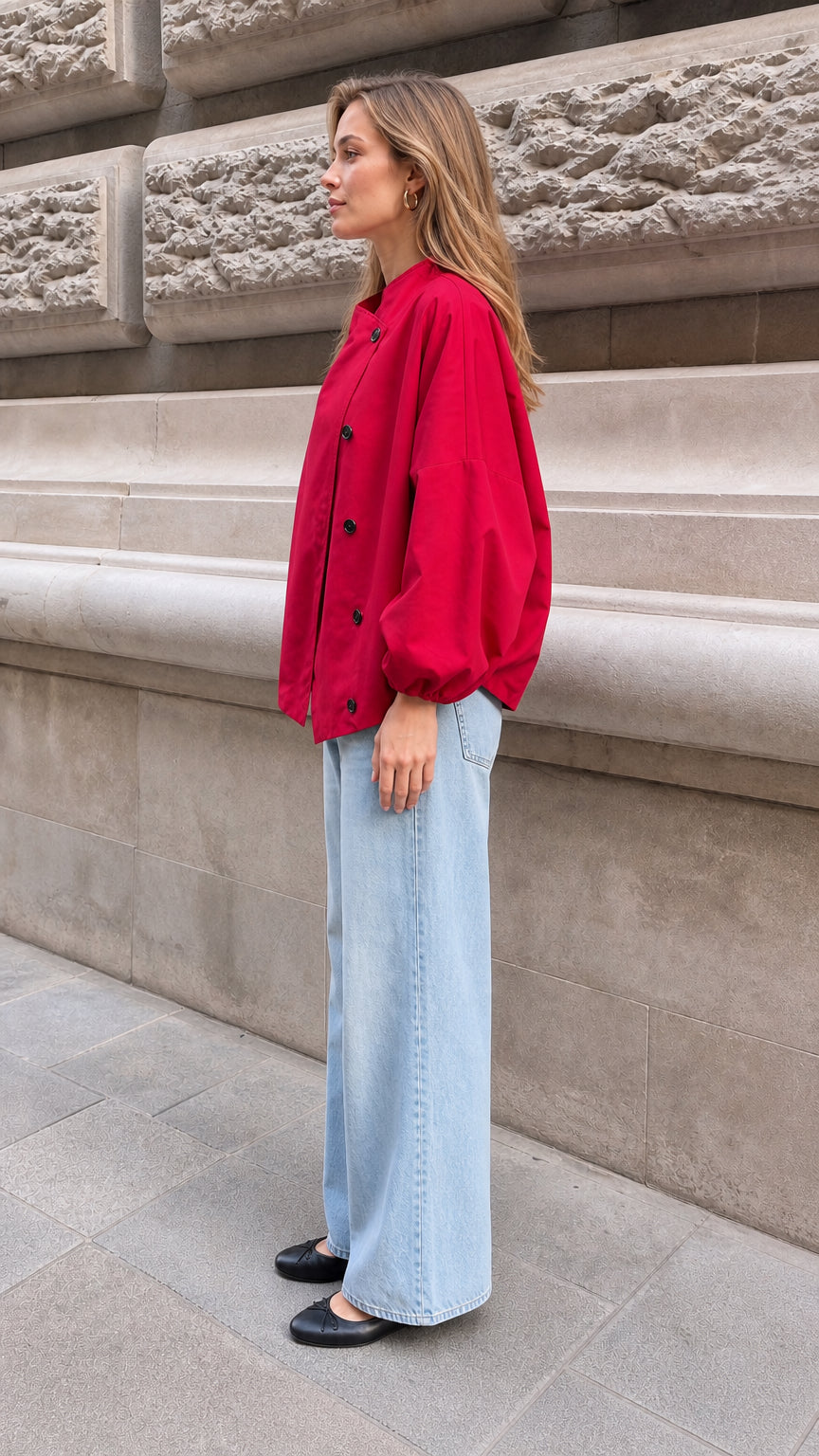 Side profile view of model wearing the loose-fit red stand collar blouse