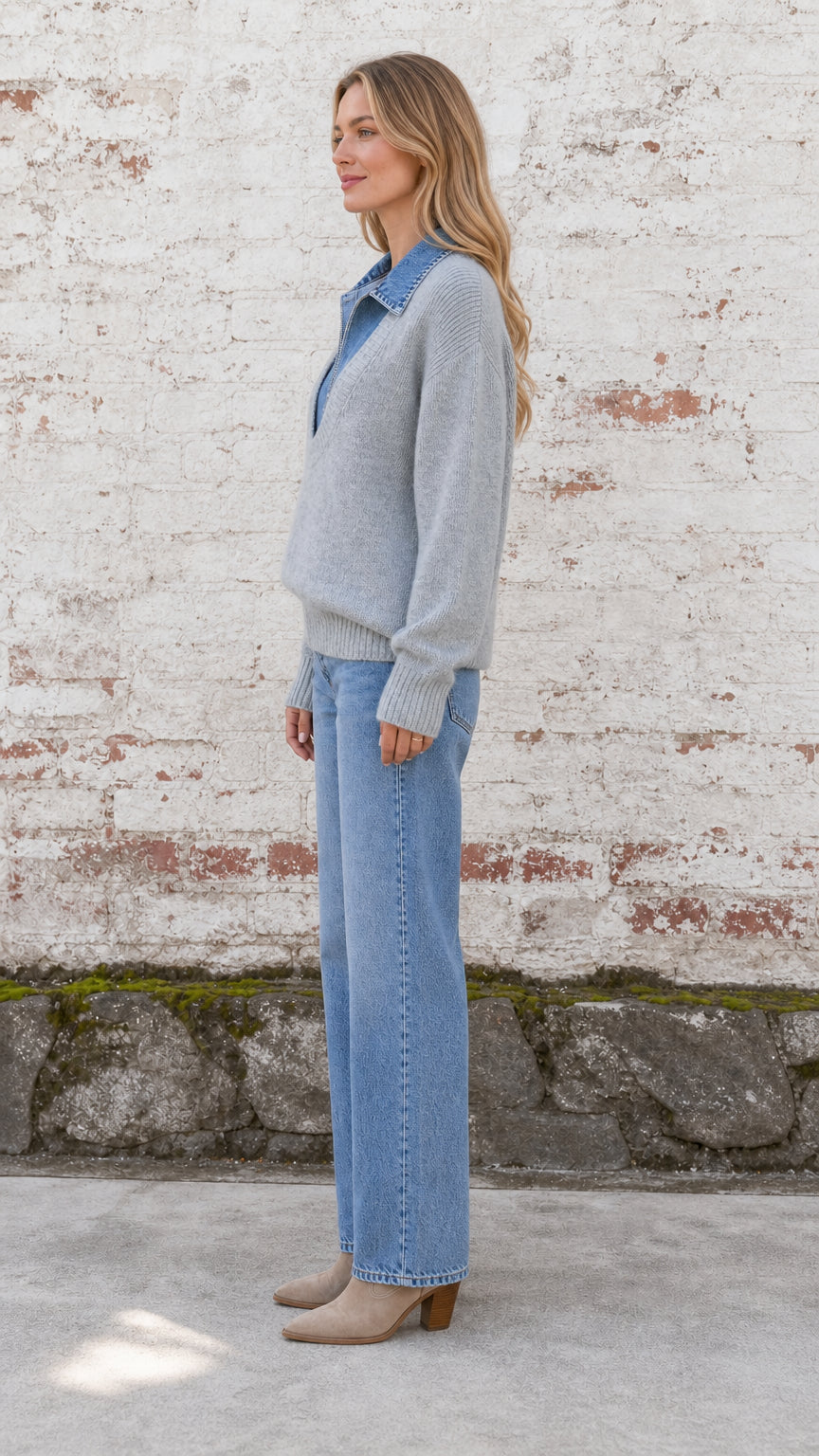 Side profile view of model wearing heather grey layered knit sweater