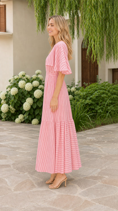 Side profile view of model wearing pink striped tiered maxi dress