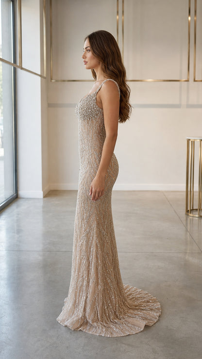 Side profile view of champagne evening gown with sweep train