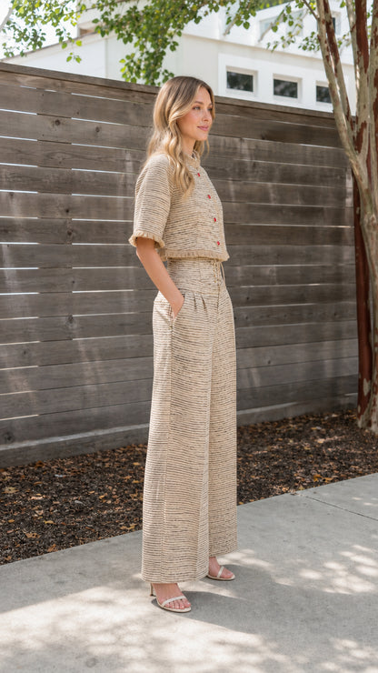 Side profile view of beige tweed outfit