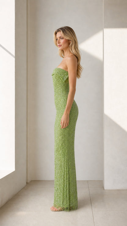 Model wearing green glittering strapless maxi dress side view