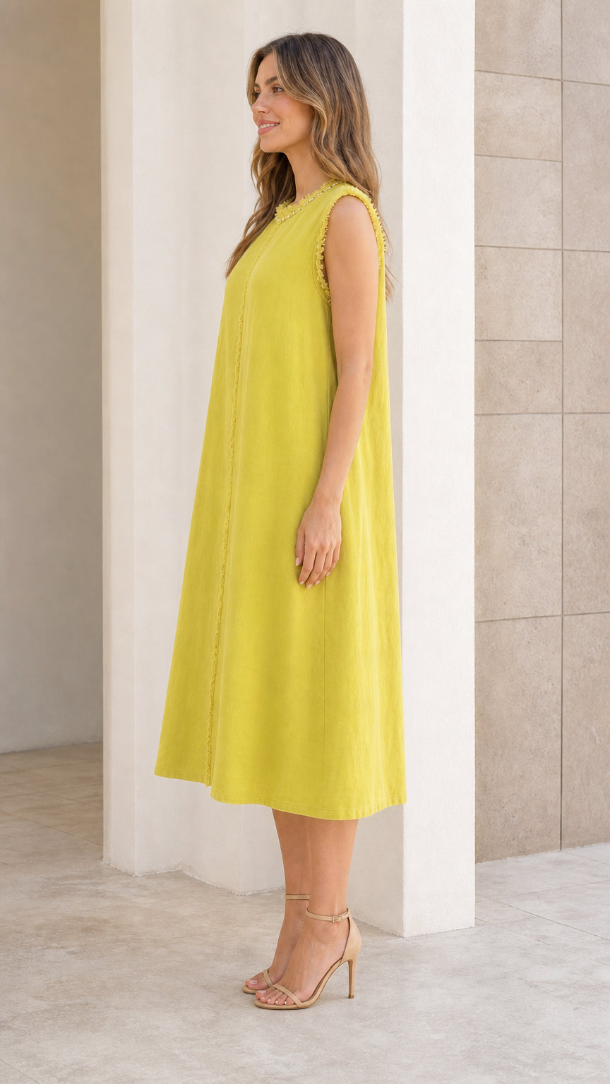 Side profile of woman in chartreuse midi dress