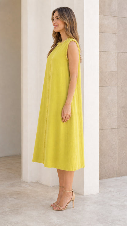 Side profile of woman in chartreuse midi dress