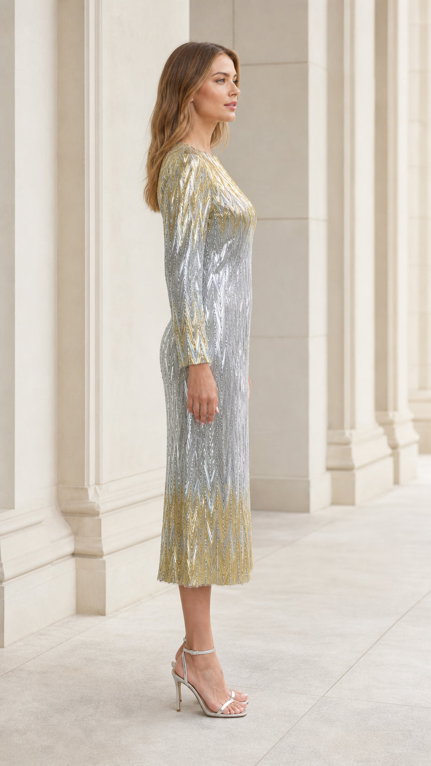 Side profile view of woman modeling silver and gold sequin midi evening dress