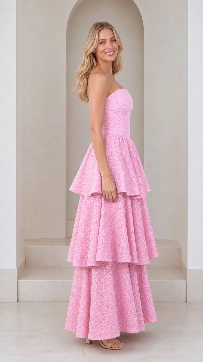 Side profile of model in pink tiered maxi dress