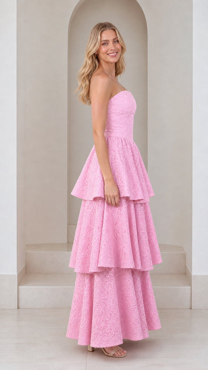 Side profile of model in pink tiered maxi dress