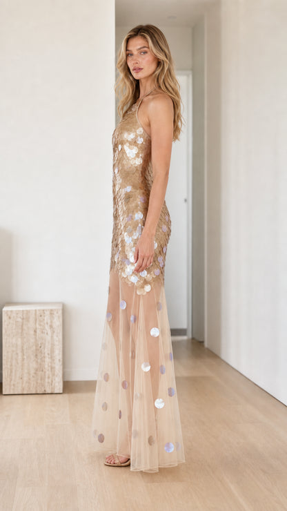 Side profile of model in Gold sequin maxi dress