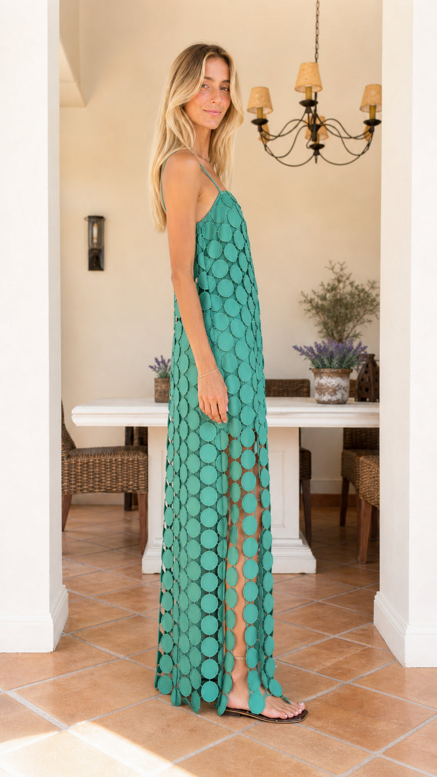 Side view of woman wearing teal cutout circle maxi dress
