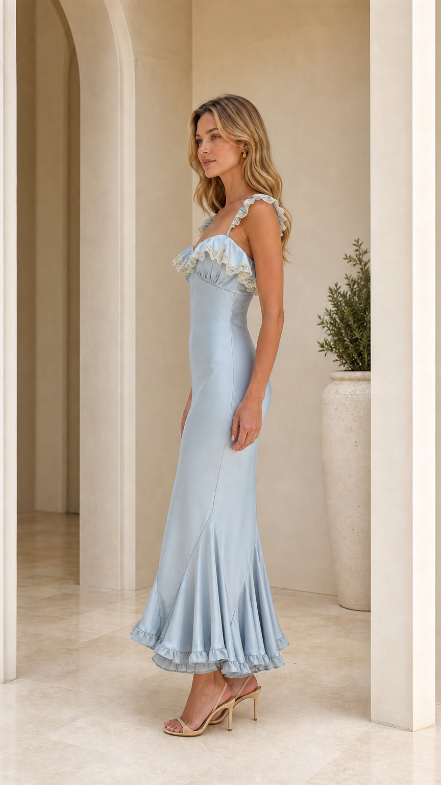 Model wearing light blue ruffle trim maxi dress side view