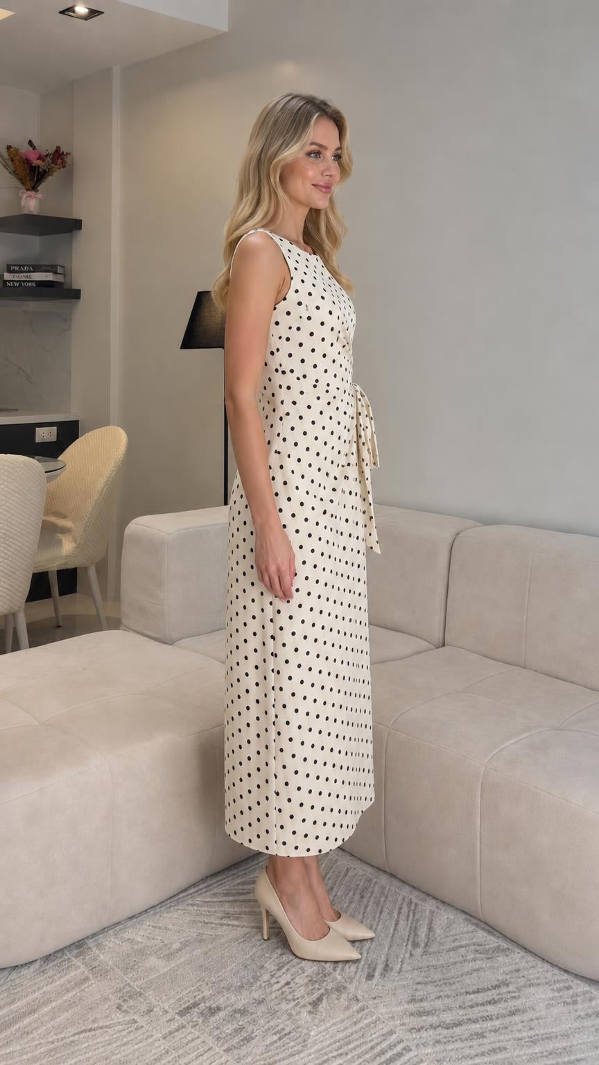 Side profile view of cream polka dot midi dress