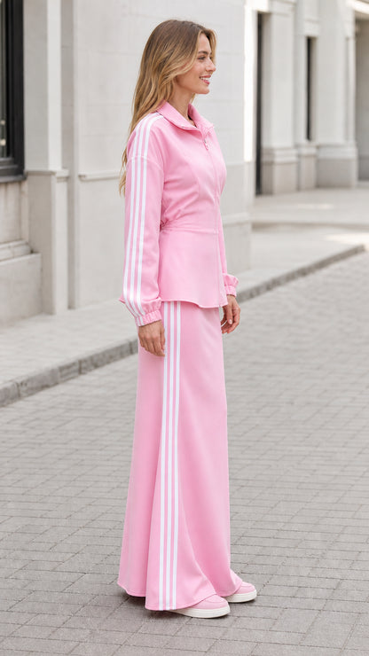 Side view of woman wearing pink sporty two-piece jacket and maxi skirt set