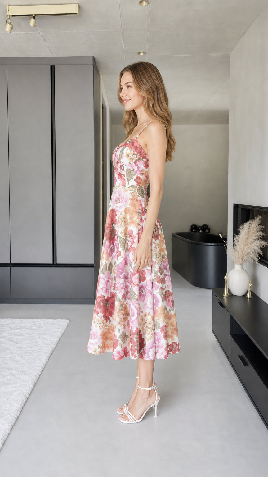 Side profile view of model in pink floral midi dress