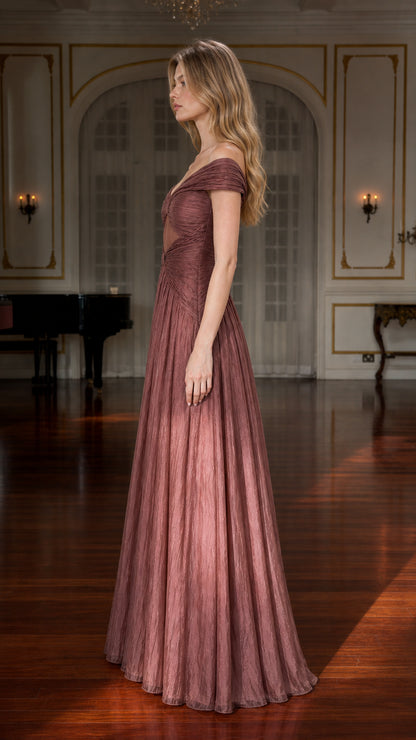 Side profile view of model in mauve pleated maxi gown