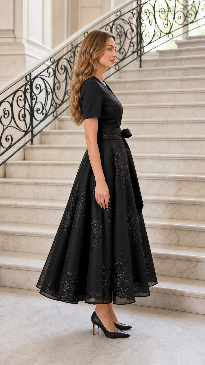 Side profile view of black midi dress
