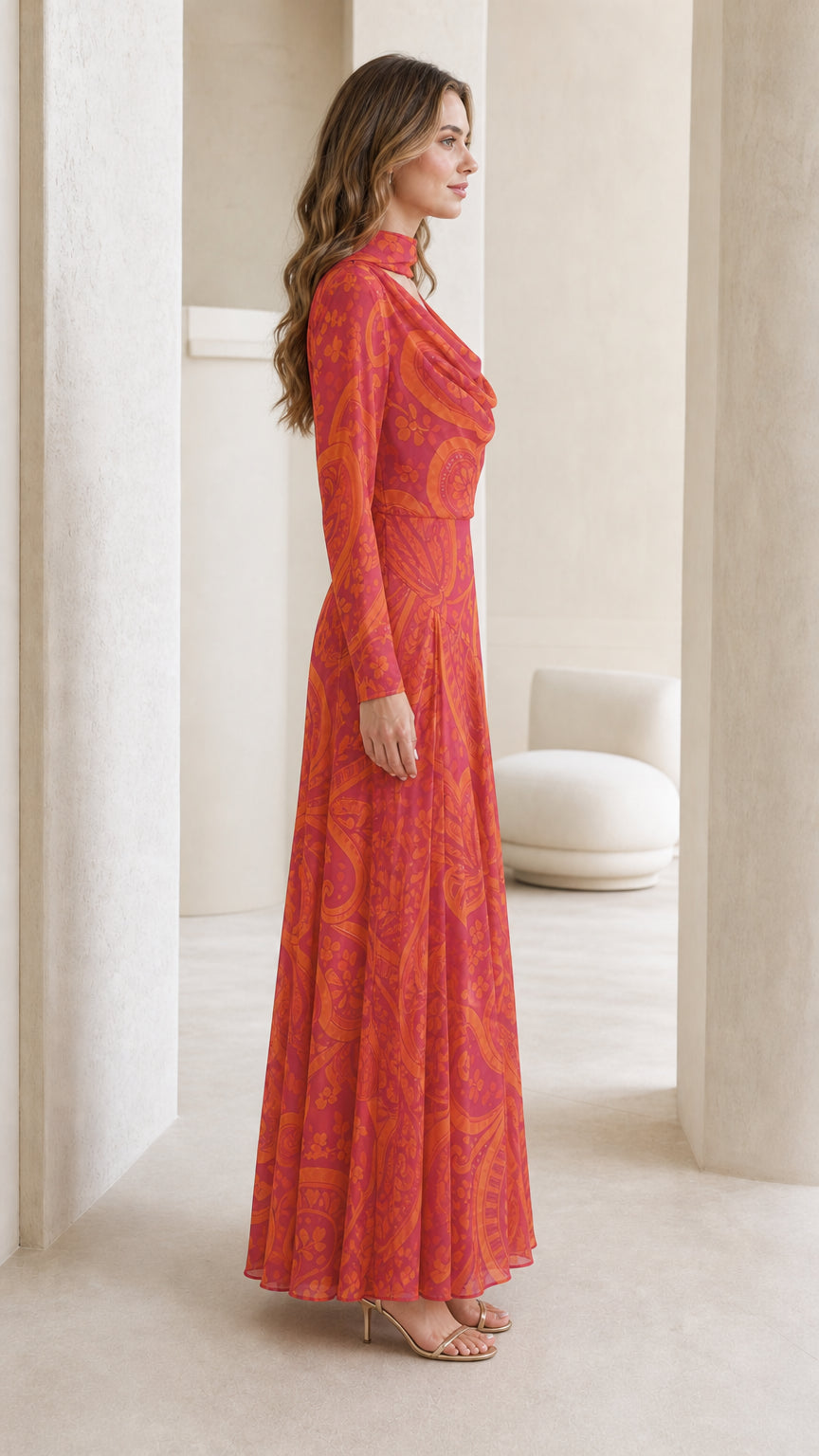 Model wearing pink paisley maxi dress, side profile view