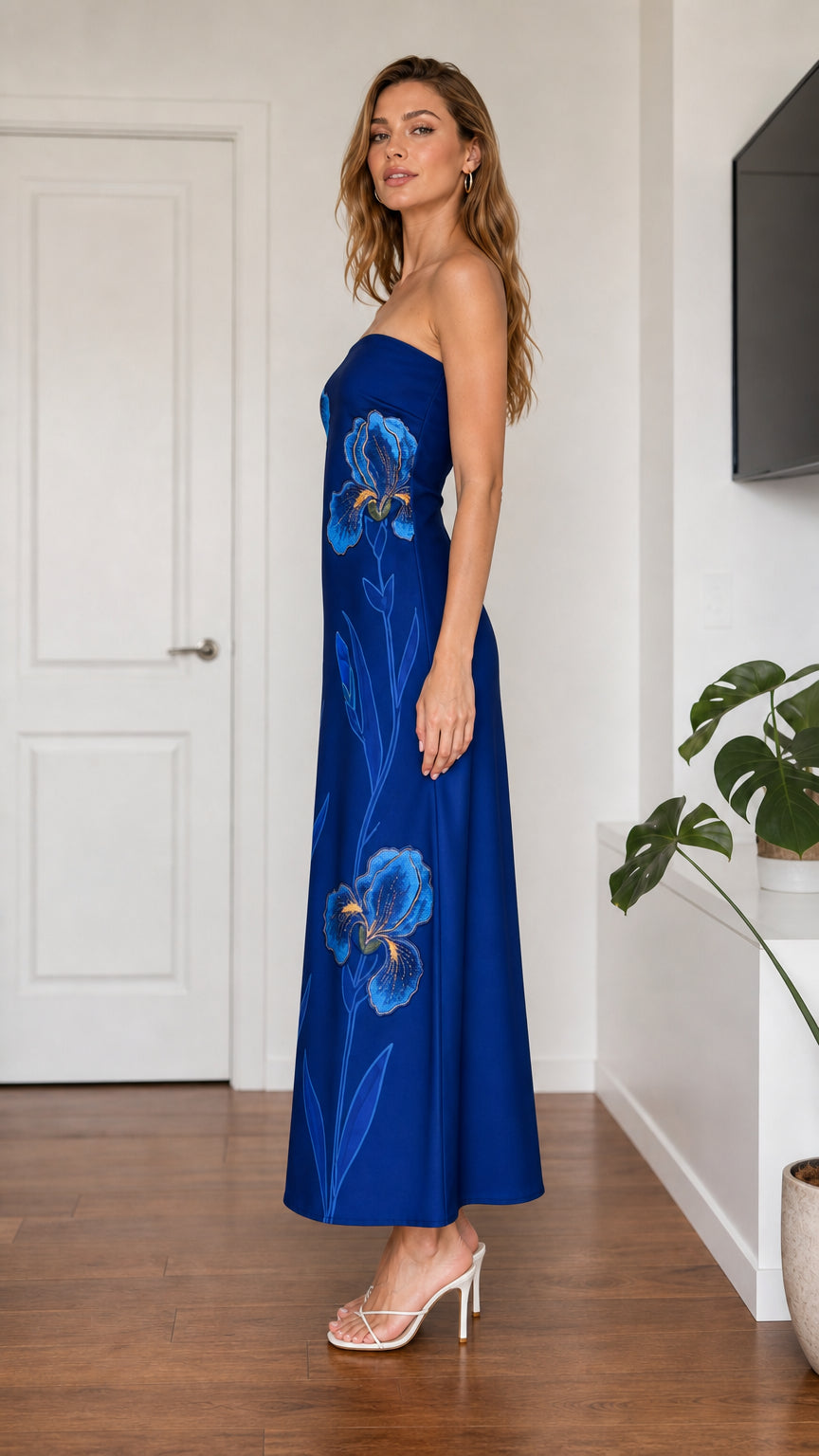 Side profile of model in royal blue embroidered maxi dress