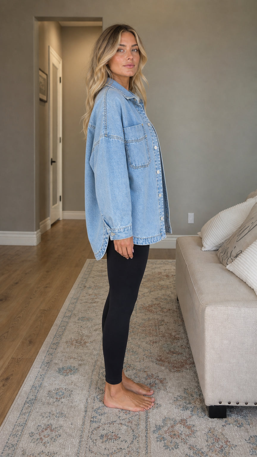 Side profile of woman wearing light blue oversized denim shirt jacket