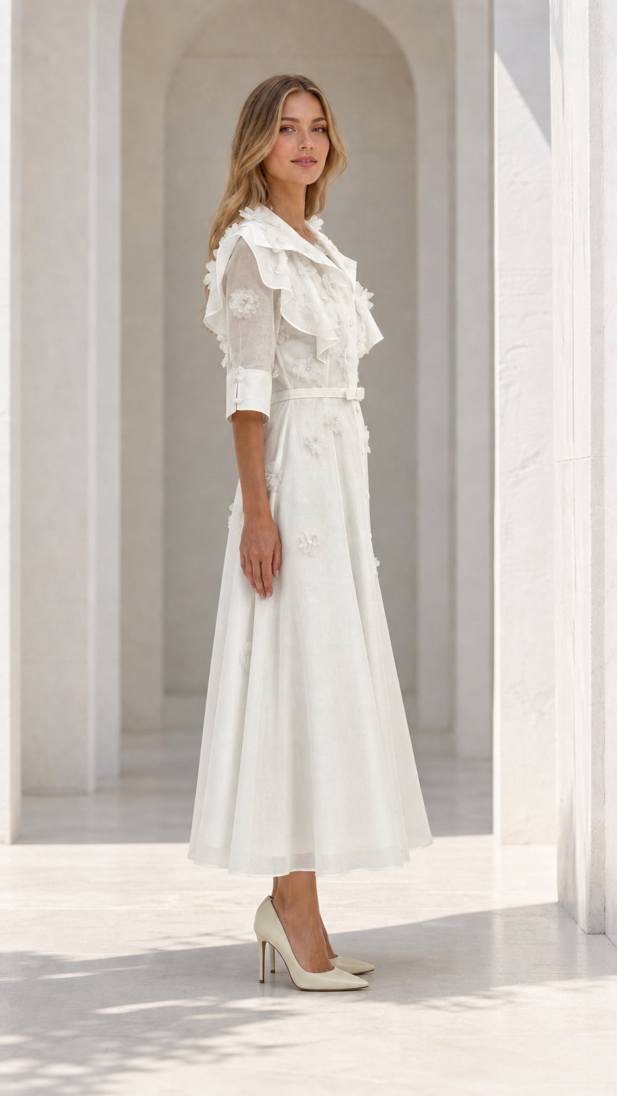 Side profile of model in white dress