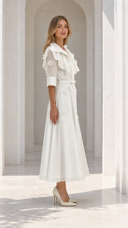 Side profile of model in white dress